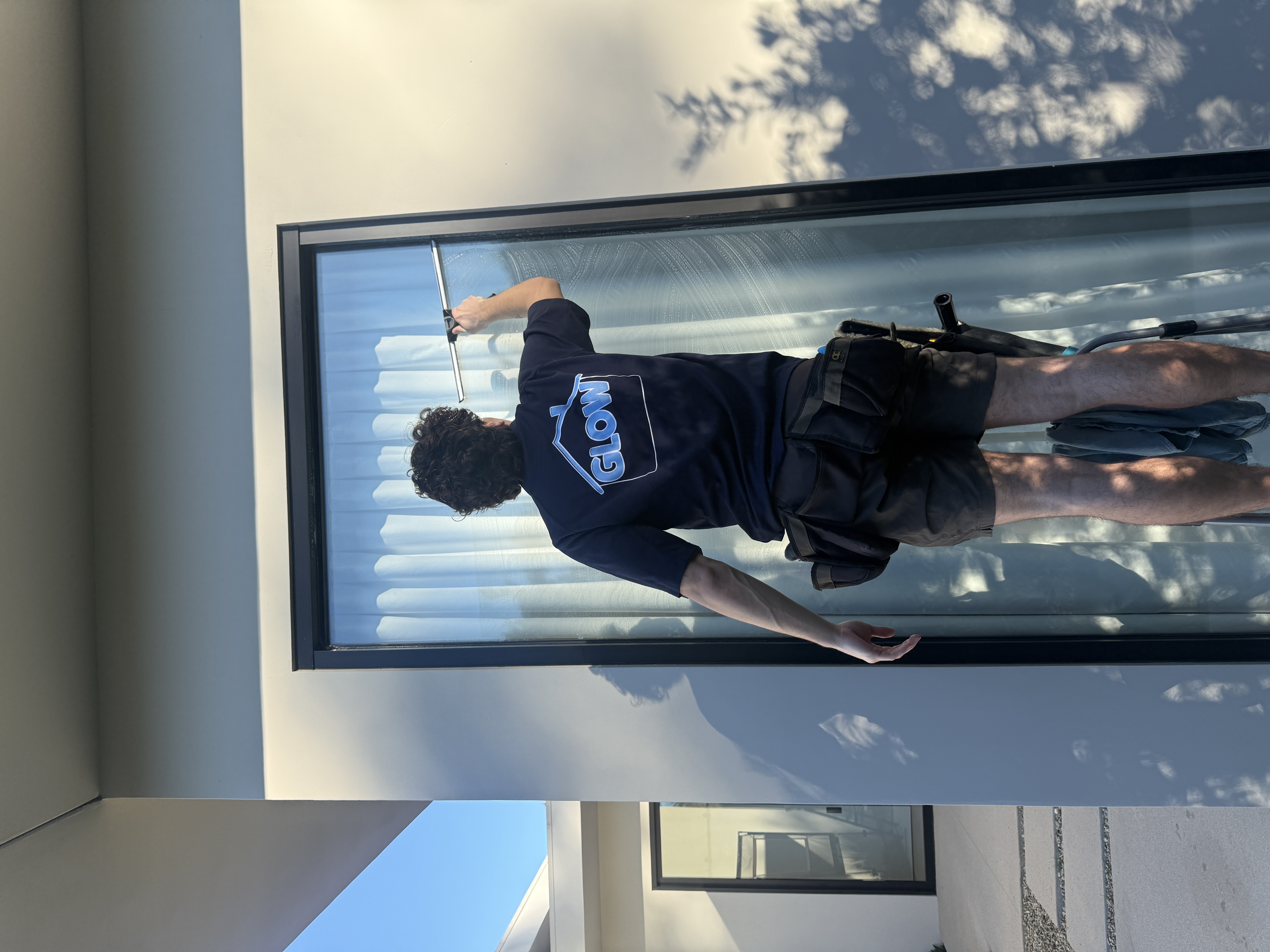 Exterior window cleaning on a modern Indian Wells home